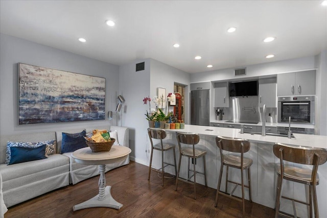 1481 Center Street Ext Unit 1102, Mount Pleasant, SC 29464 - kitchen featuring appliances with stainless steel finishes, light countertops, a kitchen bar, and recessed lighting