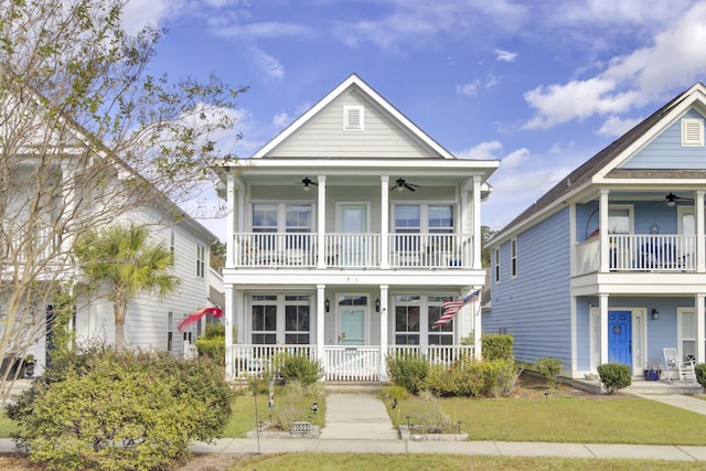 view of front of home with a ceiling fan, a front yard, covered porch, and a balcony