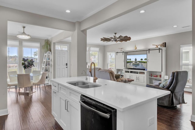 kitchen featuring a center island with sink, light countertops, open floor plan, white cabinetry, and dishwasher