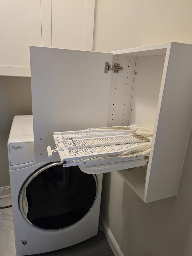 laundry area featuring washer / clothes dryer and baseboards