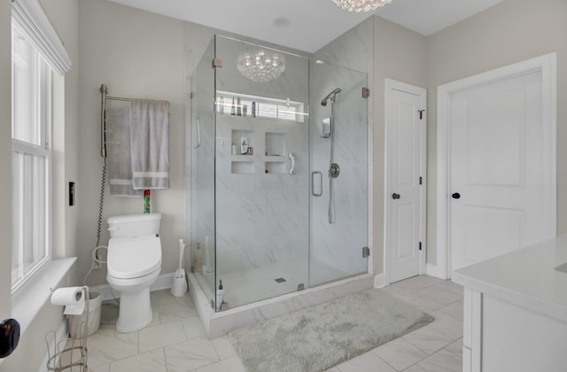 bathroom featuring marble finish floor, a marble finish shower, and a wealth of natural light