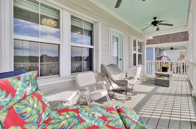 deck with covered porch and a ceiling fan