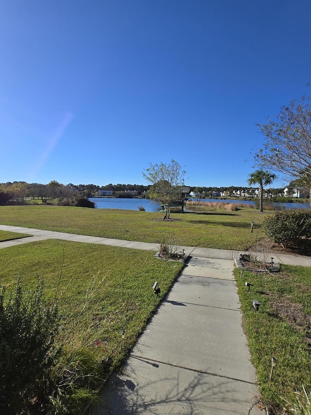 exterior space featuring a water view and a yard