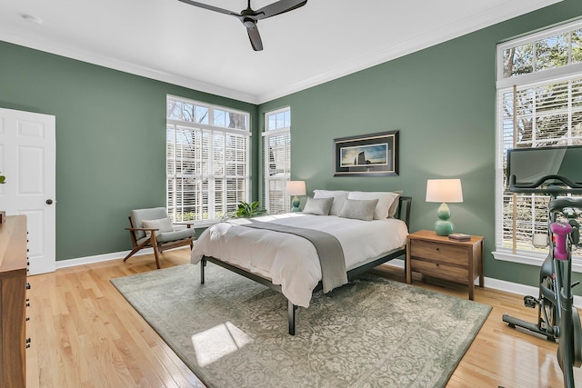 bedroom with crown molding, baseboards, and wood finished floors