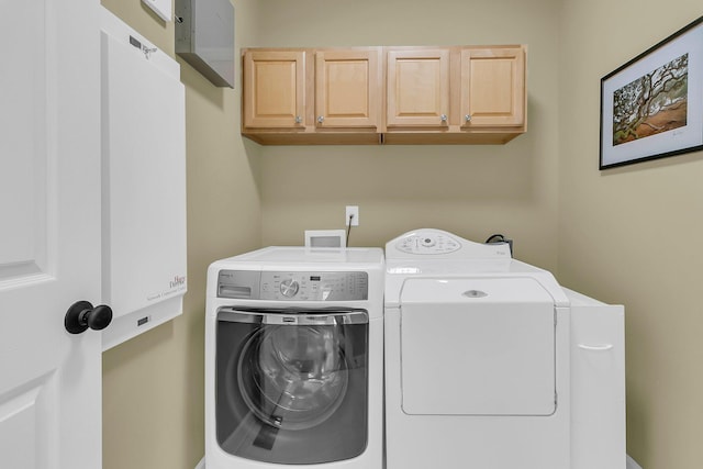 laundry area featuring cabinet space and separate washer and dryer