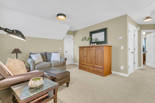 living room featuring light carpet and baseboards