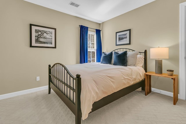 bedroom featuring light carpet, visible vents, and baseboards