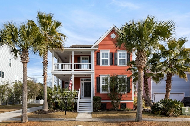 view of front of property featuring a balcony and a garage