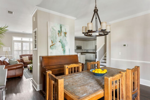 dining area with a notable chandelier, dark hardwood / wood-style flooring, and ornamental molding