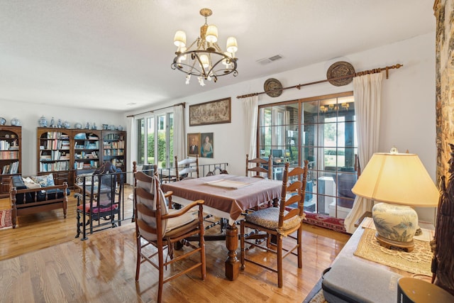 528 Wampler Dr, Charleston, SC 29412 - dining space with light wood-style floors and a chandelier