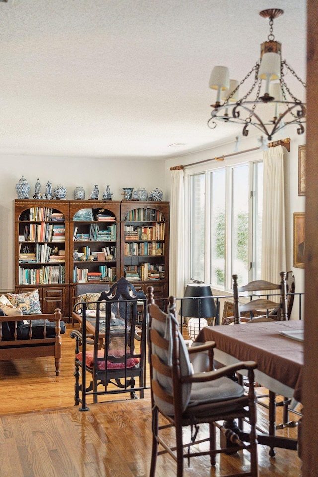 528 Wampler Dr, Charleston, SC 29412 - dining room with wood finished floors, a chandelier, and a textured ceiling