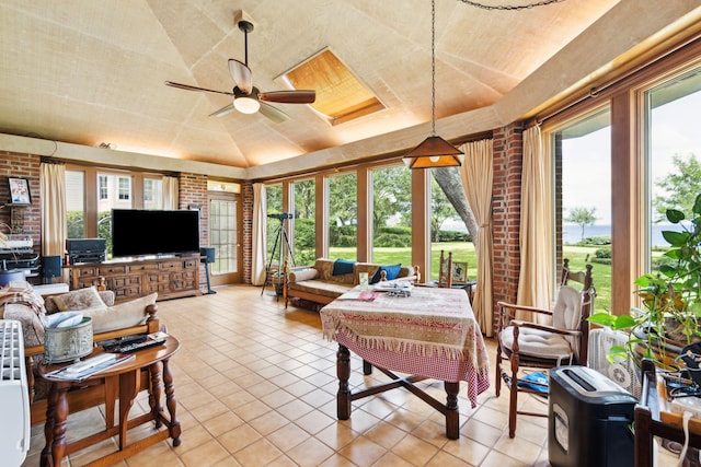 528 Wampler Dr, Charleston, SC 29412 - living room featuring light tile patterned flooring, a ceiling fan, vaulted ceiling, and brick wall