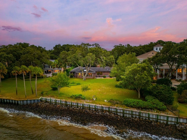 528 Wampler Dr, Charleston, SC 29412 - back of house at dusk featuring a water view and a yard