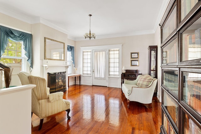 4626 Ohear Ave, North Charleston, SC 29405 - sitting room with a fireplace, a chandelier, wood finished floors, and ornamental molding