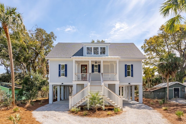 beach home featuring covered porch, a carport, and dirt driveway