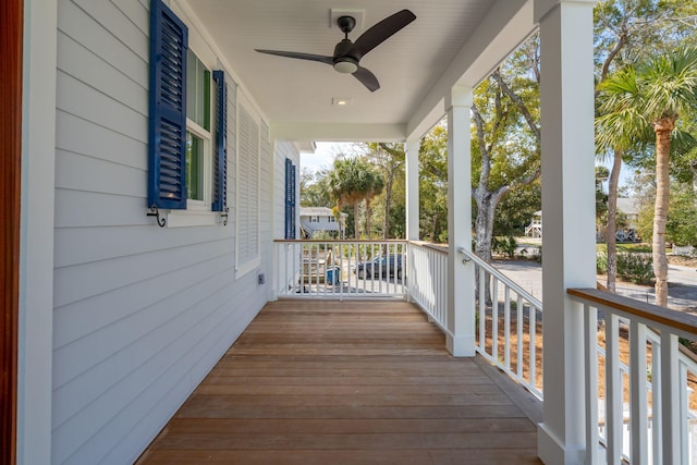 wooden terrace with covered porch and ceiling fan