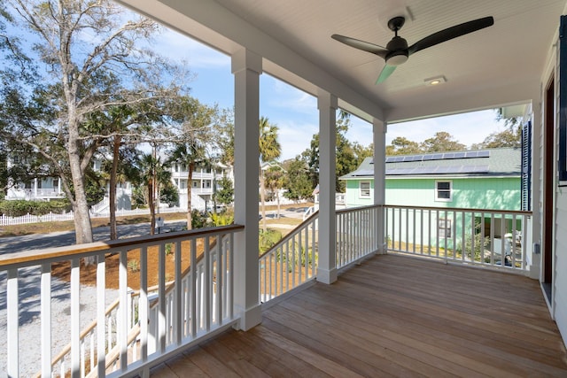 wooden terrace featuring a ceiling fan