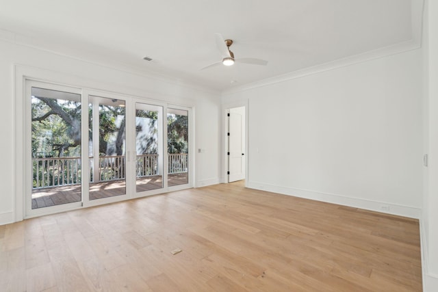 empty room featuring baseboards, ceiling fan, light wood finished floors, and crown molding