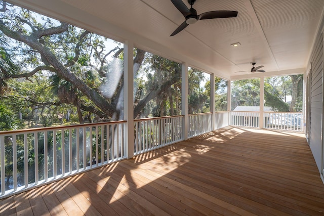 wooden terrace featuring ceiling fan