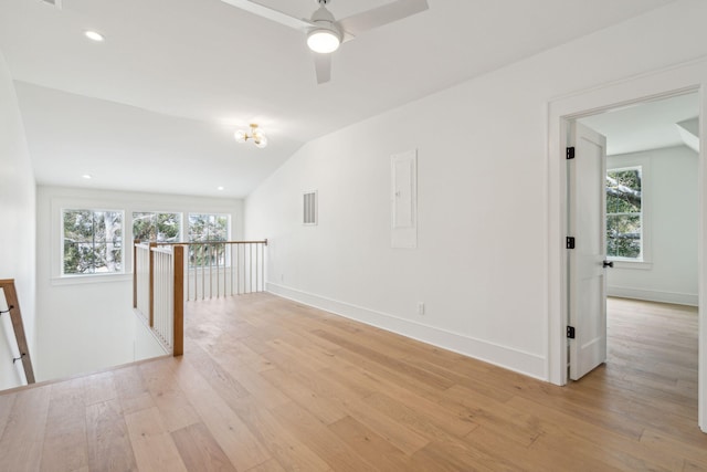 spare room with recessed lighting, visible vents, baseboards, vaulted ceiling, and light wood finished floors