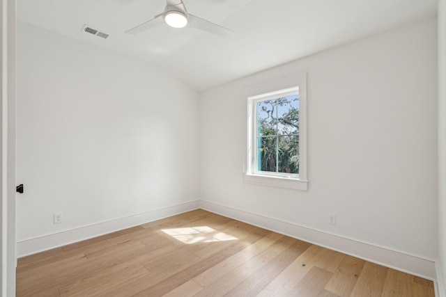 spare room with ceiling fan, light wood-style flooring, visible vents, and baseboards