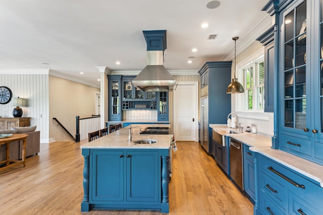 kitchen with blue cabinetry, ornamental molding, and a sink