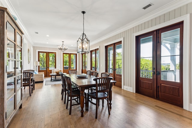 dining area featuring crown molding, french doors, wood finished floors, and visible vents