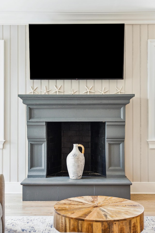 details with wood finished floors and a decorative wall