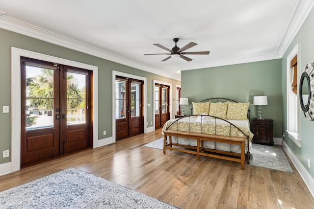 bedroom with crown molding, access to outside, french doors, and wood finished floors