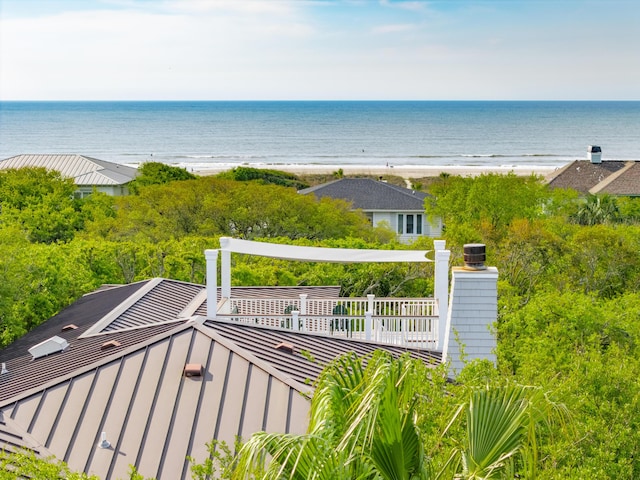 drone / aerial view featuring a beach view and a water view