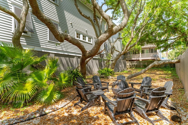 view of yard with an outdoor fire pit and fence