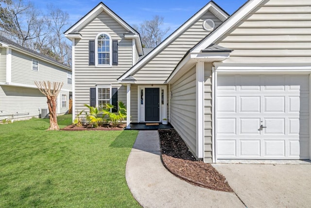 traditional-style house featuring central air condition unit, an attached garage, driveway, and a front yard