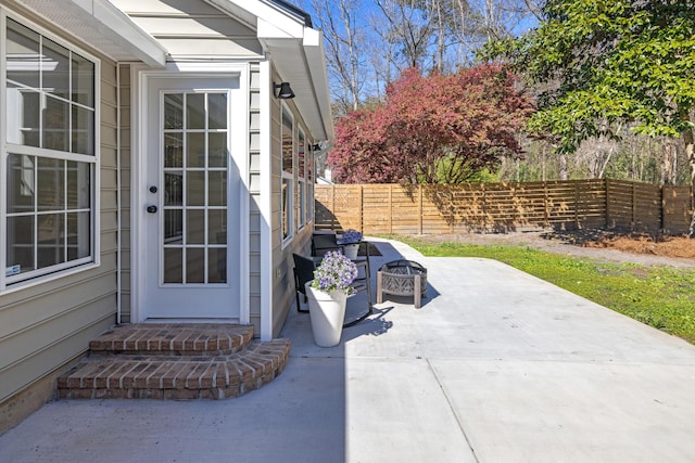 view of patio with a fenced backyard and an outdoor fire pit