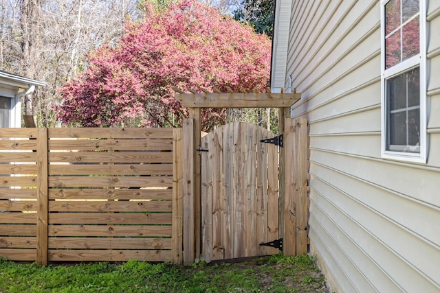 view of outbuilding with a gate and fence