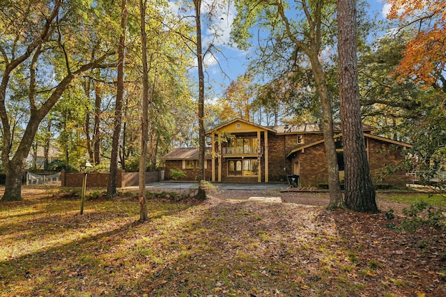 back of house with a patio area and a balcony