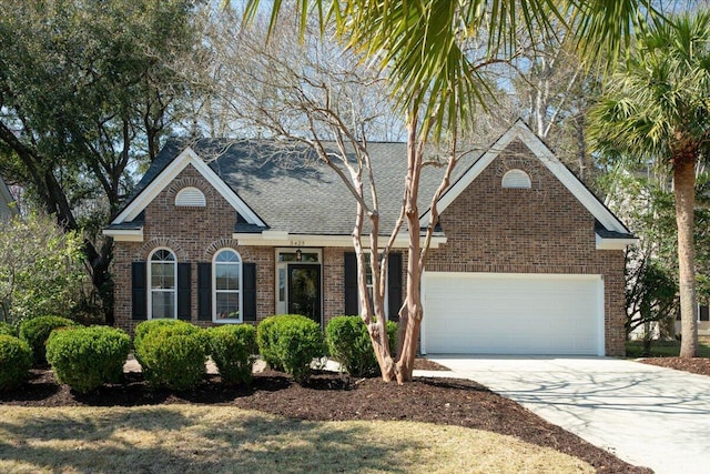 view of front of house featuring an attached garage, brick siding, driveway, and a shingled roof