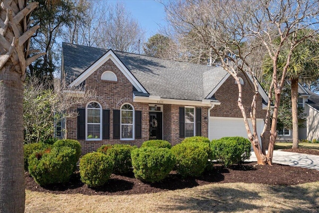 view of front facade featuring brick siding, driveway, a garage, and roof with shingles