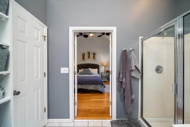 ensuite bathroom with tile patterned floors, a shower stall, and ensuite bath
