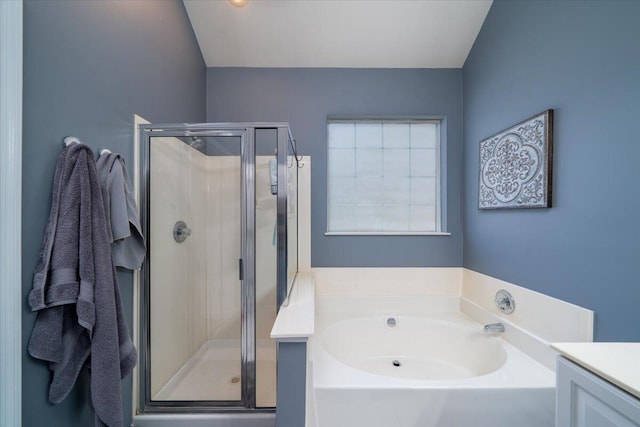 bathroom with vanity, a bath, and a stall shower