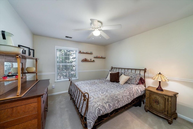 bedroom with visible vents, baseboards, carpet, and a ceiling fan