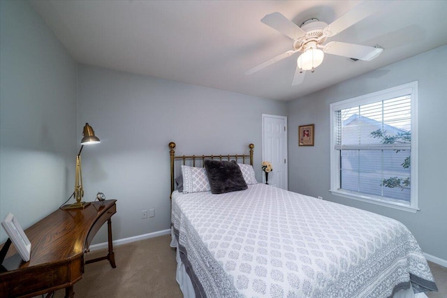 carpeted bedroom with baseboards and ceiling fan