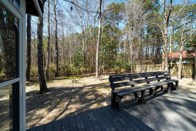 wooden terrace with a view of trees