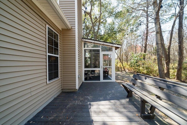 wooden deck featuring a sunroom