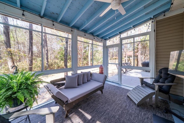 sunroom / solarium featuring lofted ceiling with beams and ceiling fan