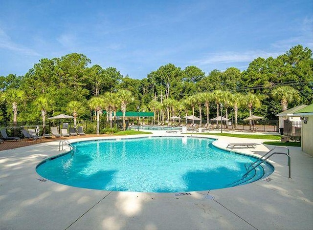 community pool featuring a patio and fence