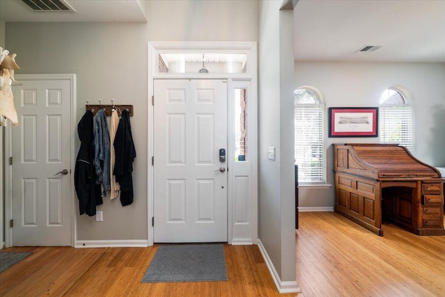 foyer with visible vents, baseboards, and light wood finished floors