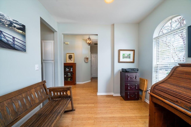 interior space featuring light wood-style flooring and baseboards