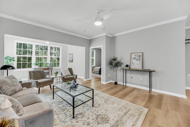 60 Fenwick Hall Aly Unit 415, Johns Island, SC 29455 - living area featuring ceiling fan, crown molding, wood finished floors, and baseboards
