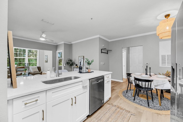 60 Fenwick Hall Aly Unit 415, Johns Island, SC 29455 - kitchen with dishwasher, a sink, light wood-type flooring, white cabinets, and light countertops