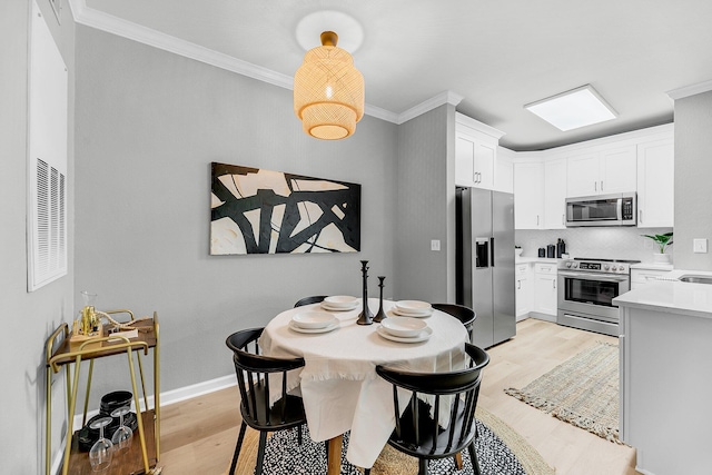 60 Fenwick Hall Aly Unit 415, Johns Island, SC 29455 - dining space featuring light wood finished floors, crown molding, and baseboards